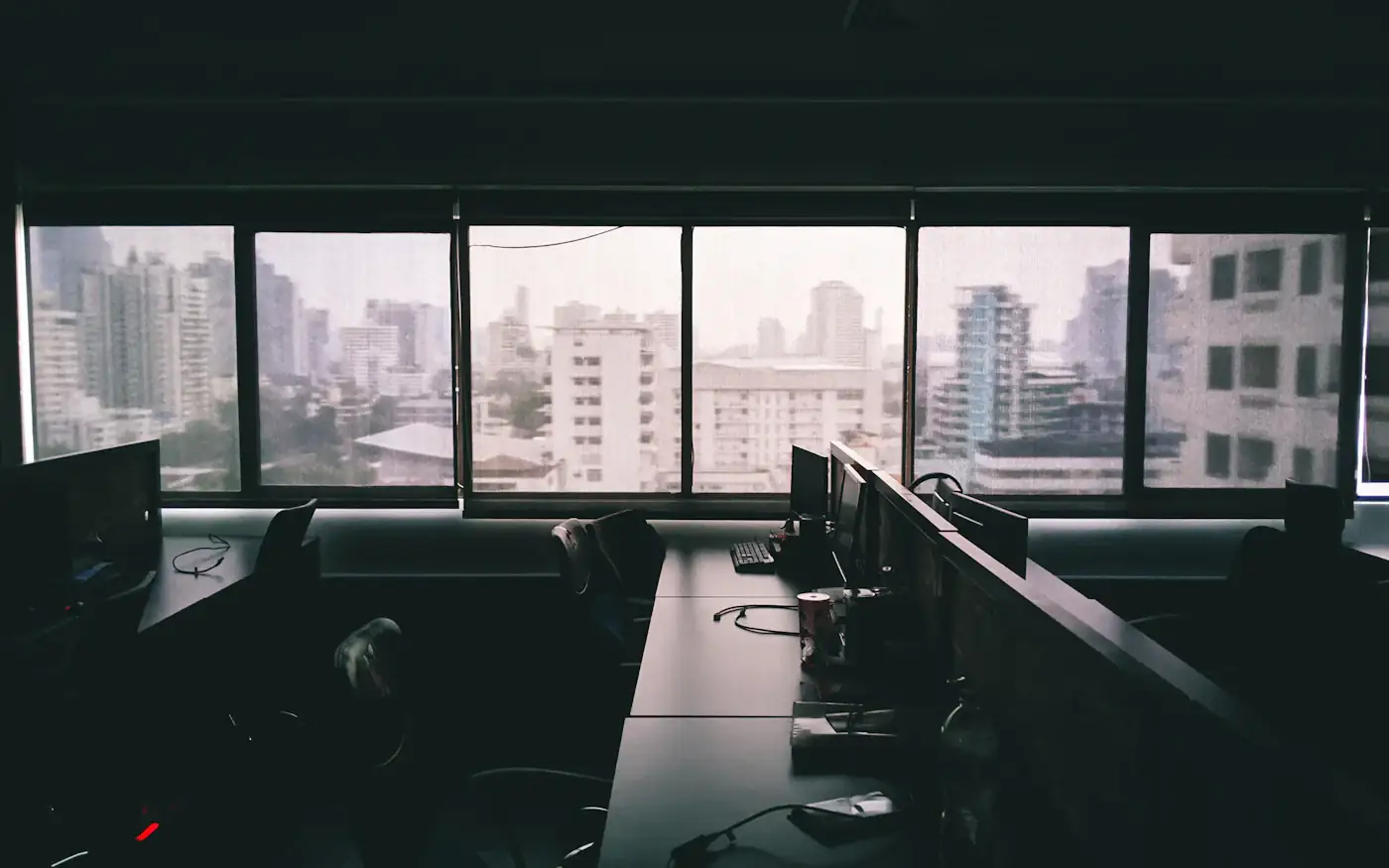An office at night with a city skyline behind