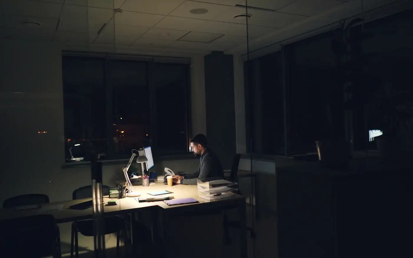 A desk lamp in a dark office